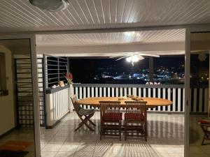 a table and chairs on a balcony with a view at MARINA DU MARIN in Le Marin