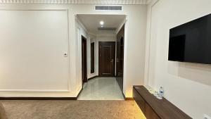 a living room with a flat screen tv on a wall at Reikartz Sote Tashkent in Tashkent