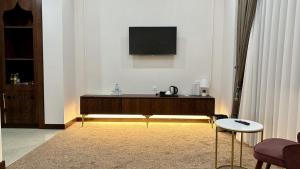 a living room with a flat screen tv on a wall at Reikartz Sote Tashkent in Tashkent