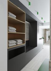a walk in closet with towels on shelves at Porto Platanias Beach Luxury Selection - Adults Only in Plataniás