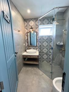 a bathroom with a shower and a sink and a mirror at Seamoni Seaview Villa 02 - Novaworld Phan Thiết in Phan Thiet