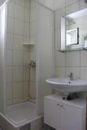 a white bathroom with a sink and a shower at Apartments Lampion in Vir +40 photos