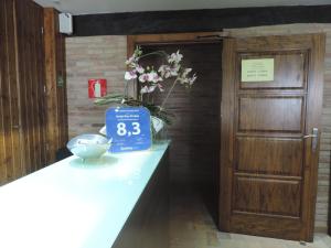 a table with a blue sign on it next to a door at Hotel Mas Prades in Deltebre