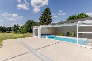 a swimming pool in a house with a building at Le saint remeau in Le Jard