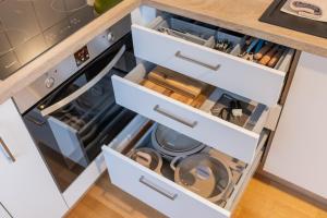 a kitchen with white drawers and an open dishwasher at EASYLIFE - Apartment Retro in Eisenach