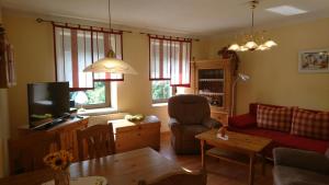 a living room with a couch and a tv at Ferienwohnungen Bauer in Kurort Oberwiesenthal