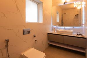 a bathroom with a sink and a mirror at StayVista at Alpine Haven - Mukteshwar in Rāmgarh