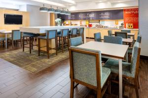 a dining area with tables and chairs in a restaurant at Hampton Inn Richmond-SW Hull Street in Midlothian