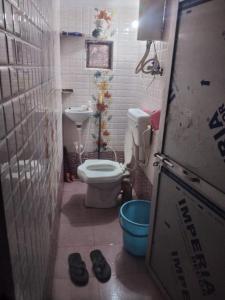 a small bathroom with a toilet and a sink at RINGOSTAR PAYING GUEST HOUSE & ROOF TOP RESTAURENT in Būndi