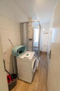 a bathroom with a washing machine in a room at RR - Stylish Apartment 50qm - WIFI - Washer - TV in Magdeburg