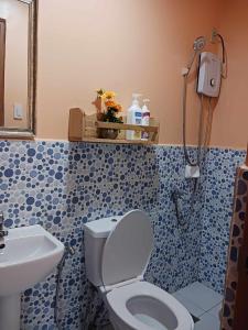 a bathroom with a toilet and a sink at Dreamstay Hostel in Moalboal +62 photos