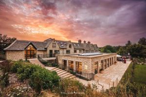 a large stone house with a large yard at The Pear Tree in Purton