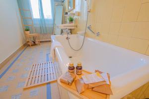 a bathroom with a bath tub in a room at L'instant champenois & son annexe in Bréviandes