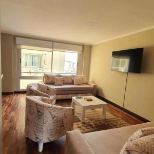 a living room with a couch and a table at Departamento Caseros Desing in Salta