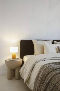 a bedroom with a bed and a lamp on a table at Luxe appartement in Antwerpen in Antwerp