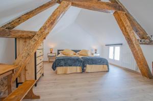 een slaapkamer met een bed en een houten vloer bij Le paco in Bar-sur-Aube