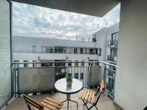 a balcony with a table and chairs on a building at Bp-EST CP in Budapest