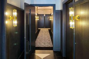 a hallway with two doors and a tile floor at TRYP by Wyndham Wellington, Tory Street in Wellington