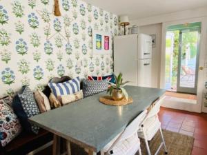 a living room with a table and a couch at Whitstable Cottage - Perfect Location in Whitstable