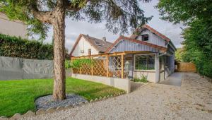 a house with a tree in front of it at Le refuge in Saint-Julien-les-Villas