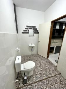 a bathroom with a toilet and a sink at Linden Apartment 