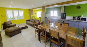 a kitchen with a large wooden table in a room at Le gite des remparts in Chaource