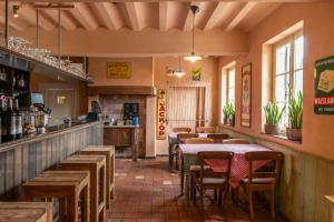 a restaurant with tables and chairs and a bar at Herberg De Zwaan in Sint-Truiden