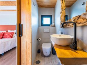 a bathroom with a sink and a toilet in a room at Villa Luxury Sunrise Private Pool Corralejo By Holidays Home in Corralejo +35 photos