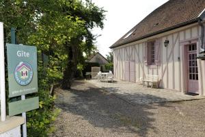 a building with a sign in front of it at La compagnie du soleil in Bligny +2 photos