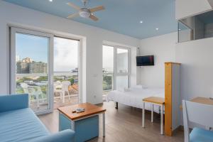 a bedroom with a bed and a view of the ocean at Suites by GoettenMar in Platja d'Aro