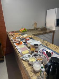 a kitchen counter topped with lots of food at Pousada Tia Alice in Penha