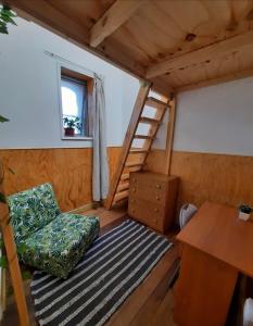 a room with a chair and stairs in a tiny house at Casa Elias Hostel-Av Elias in Valparaíso