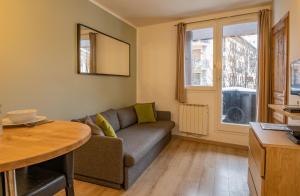 a living room with a couch and a table at Apartment Lognan 1 - A Chamonix Mont Blanc Haven in Chamonix