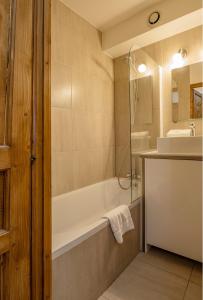 a bathroom with a tub and a sink at Apartment Lognan 1 in Chamonix