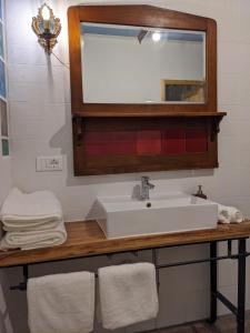 a bathroom with a sink and a mirror and towels at Castel San Mauro in Gorizia