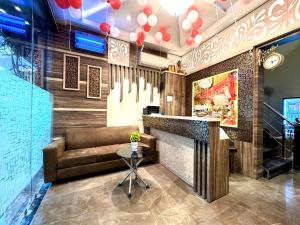 a bar in a restaurant with a couch and a table at Hotel Heaven View - 50m From Golden Temple in Amritsar