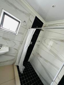 a bathroom with a shower and a sink at Victoria Guest Lodge in Bellville