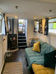 a living room with a couch in a tiny house at Narrow Boat moored in London in London