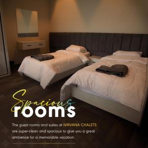two beds in a hotel room with a advert for swimlins rooms at Nirvana Chalets in Jerash