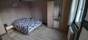 a bedroom with a bed and a window and a door at Gite Seb et Delphine in Montauban-de-Picardie