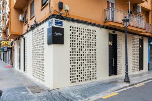 a building with a large white garage door on a street at Anelsa Torres de Serranos 3 in Valencia