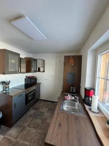 a kitchen with a sink and a counter top at Ferienhaus Melzower Waldhaus Montagewohnung in Melzow