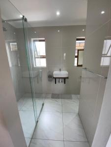 a bathroom with a shower and a sink at Aloe Studio in Jeffreys Bay
