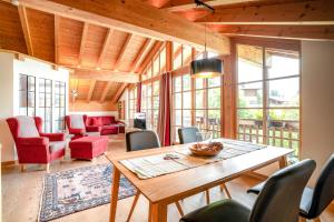 a living room with a wooden table and chairs at Alpenhaus Oberstdorf in Oberstdorf