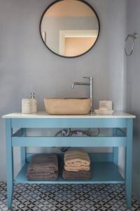 uma casa de banho com um lavatório azul e um espelho. em Luxurious Villa Nadoria, Ithaca Island em Vathi