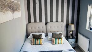 - une chambre dotée d'un lit avec un mur rayé dans l'établissement Stunning 1 bedroom apartment with courtyard - Flat 3, à Bedford