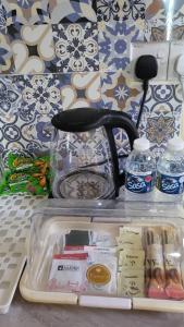 a refrigerator with its door open with food and water at The Backyard Cottage 168 in Keningau