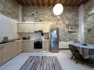 a kitchen with a stainless steel refrigerator and a table at Teleport Coliving Cyprus in Pano Lefkara