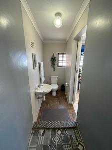 a bathroom with a toilet and a sink at Hide 2 On Rees in East London