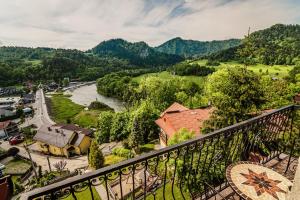 a view from a balcony of a town and a river at Apartamenty Widok in Szczawnica